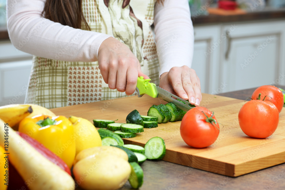Young Woman Cooking in the kitchen. Healthy Food Young Woman Cooking in the kitchen. Healthy Food