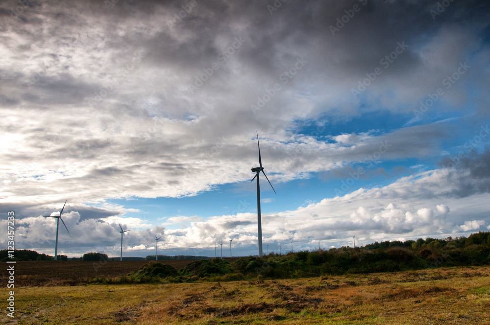Obraz premium Wind turbine on autumnal background