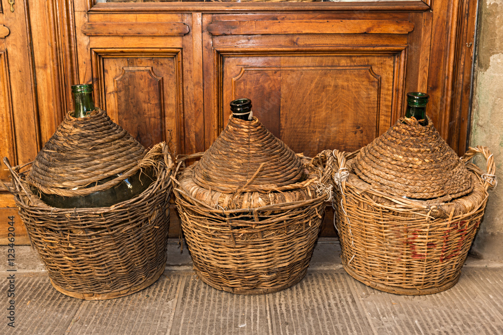 Garrafas de cristal y mimbre. Stock Photo | Adobe Stock