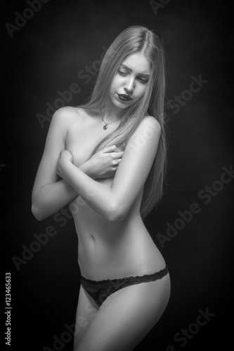 sensual young woman covering her naked body, monochrome © tugolukof