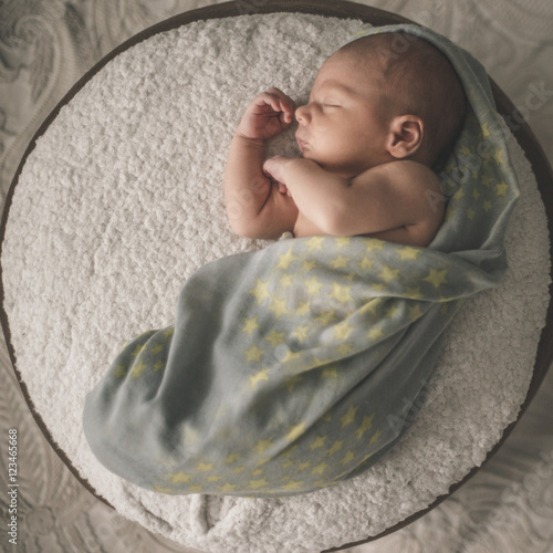 newborn baby laying down sleeping.