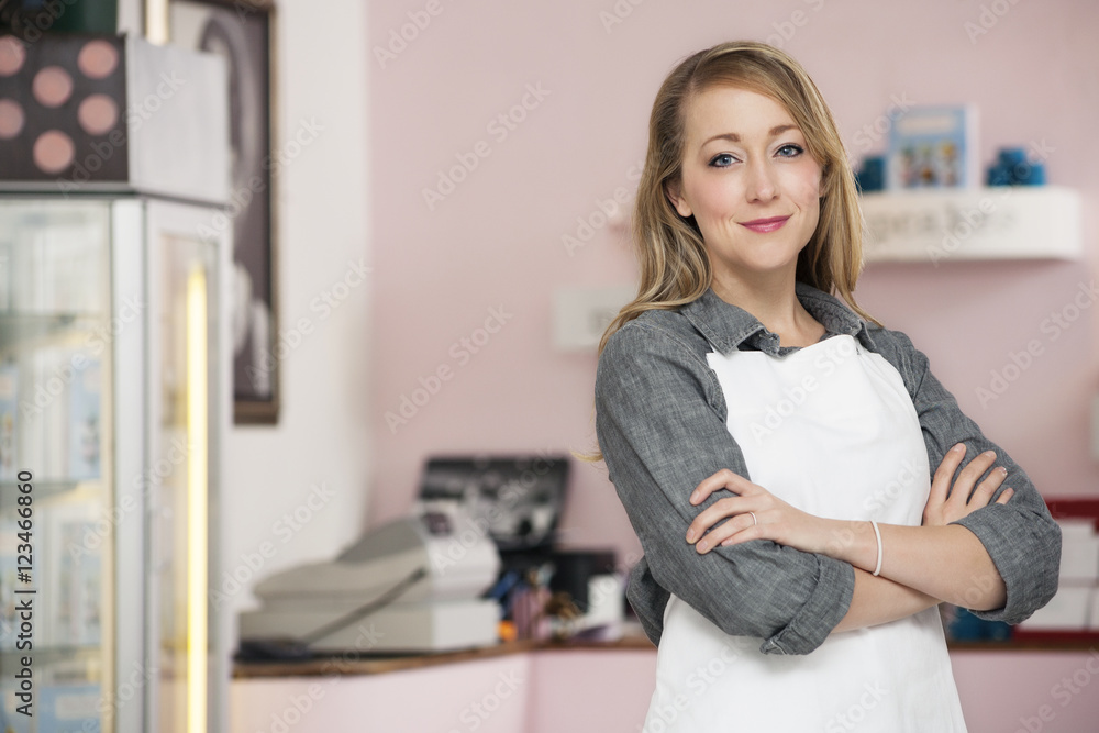 Portrait of confident owner standing in cake shop Portrait of confident owner standing in cake shop