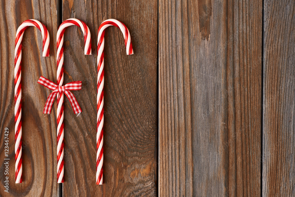 Fototapeta premium Christmas cane on wooden background