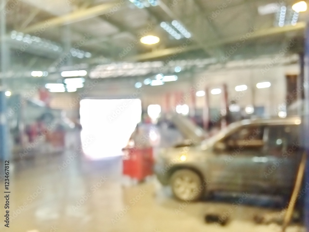 Blurred environment inside the garage with technician