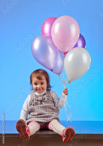  little girl with balloons on a blue background