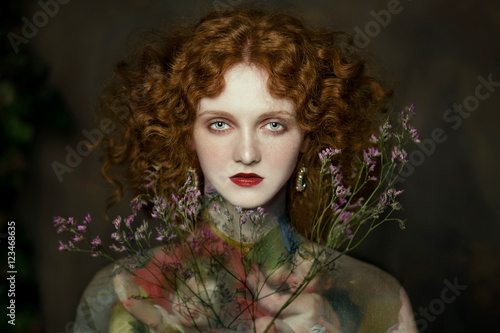 Portrait of young woman holding flower