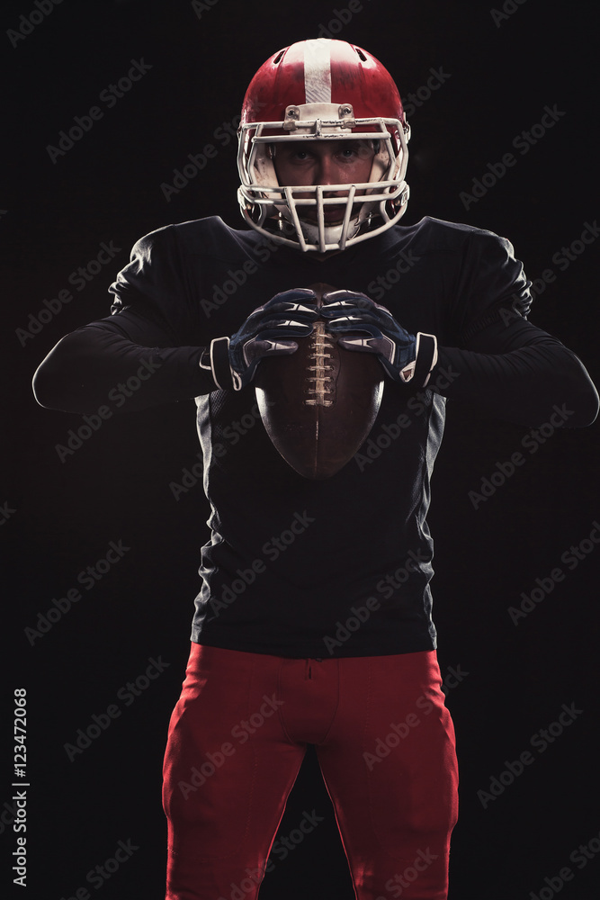 Football player on dark background