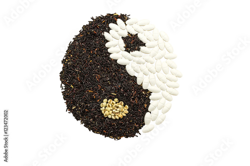 Black rice and white pill forming a yin yang symbol indicate blending of herb and medicine isolated on white background.Saved with clipping path