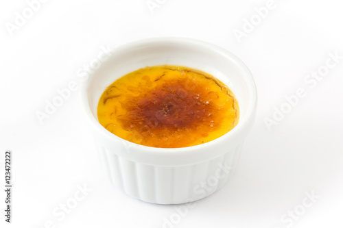 Traditional French creme brulee dessert with caramelized sugar on top, isolated on white background.