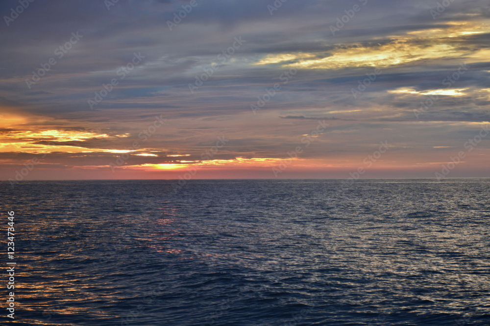 Fototapeta premium Reflective Seas Beneath Sunrise