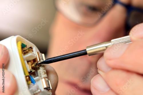 Electrician rewiring a UK 13 amp domestic electric plug