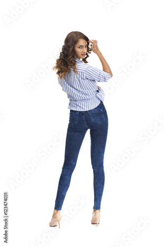 Young beautiful brunette woman in blue jeans