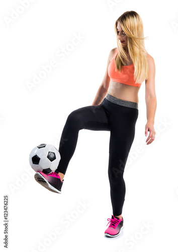 Pretty blonde girl holding a soccer ball