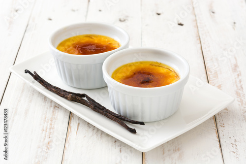 Tableau sur toile Traditional French creme brulee dessert with caramelized sugar on top, on white