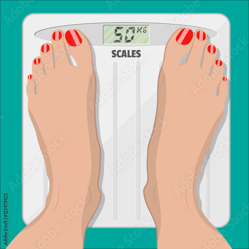 electronic scales and female feet with pedicure