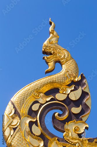Beautiful Golden Thai Lanna Architecture: Naga wood carved at Chapel Roof of Wat Inthakhin Sadue Muang, Chiangmai, THAILAND.