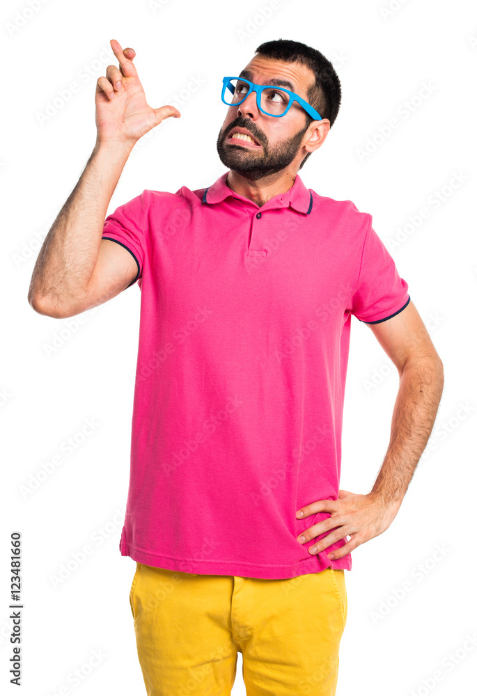 Man with colorful clothes with his fingers crossing Man with colorful clothes with his fingers crossing