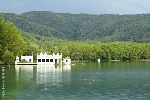 Lake Banyoles is the largest lake in Catalonia, Tourists enjoy the good weather and relax for boating and wooded paths. photo