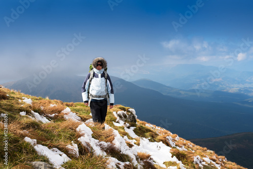 Young Woman hiking in the Mountains.