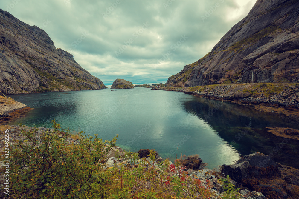 Fjord in evening in rainy day, Rocky beach. Beautiful nature of Norway. Lofoten islands