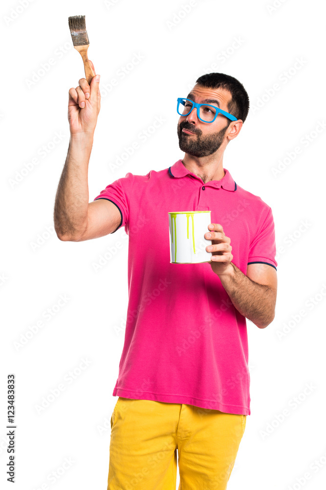 Man with colorful clothes holding a paint pot Man with colorful clothes holding a paint pot