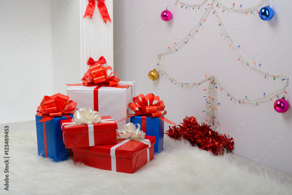 Christmas gifts by the fireplace and fir-tree Christmas gifts by the fireplace and fir-tree