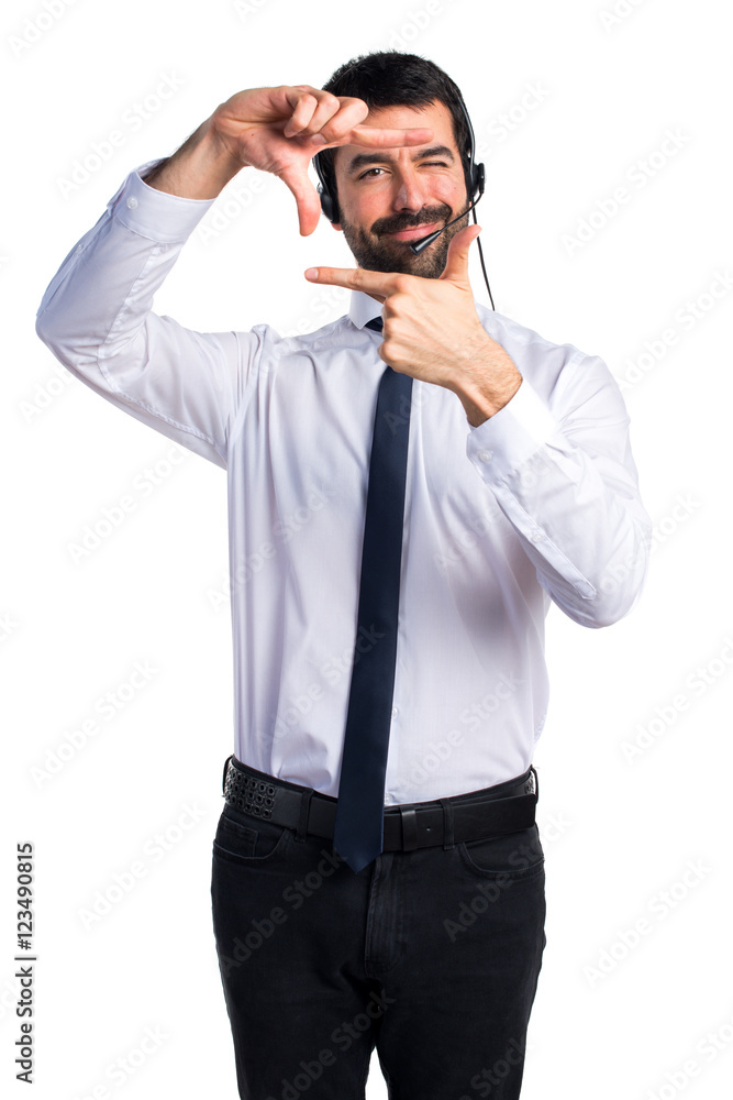 Young man with a headset focusing with his fingers Young man with a headset focusing with his fingers