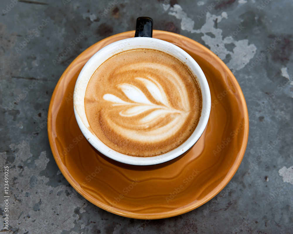 Art milk mocha coffee with foam on metal table Art milk mocha coffee with foam on metal table