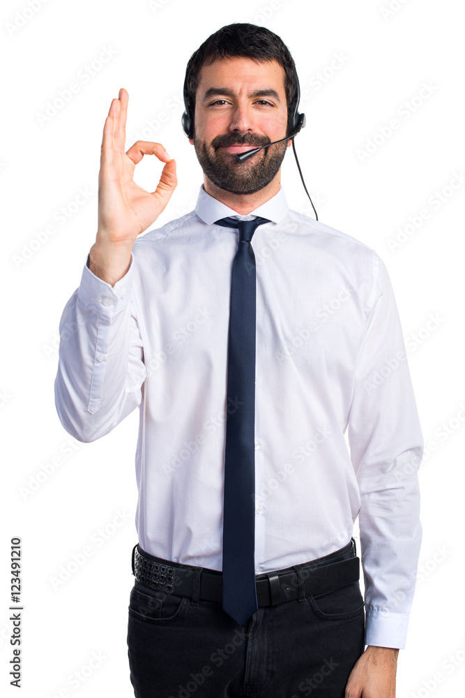 Young man with a headset making OK sign Young man with a headset making OK sign