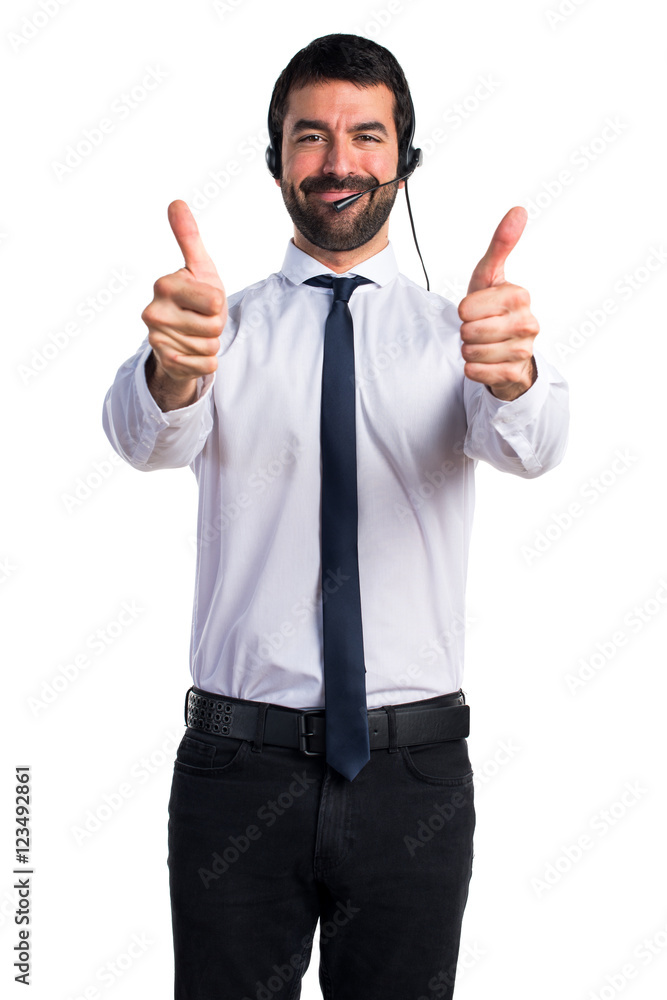 Young man with a headset with thumb up Young man with a headset with thumb up