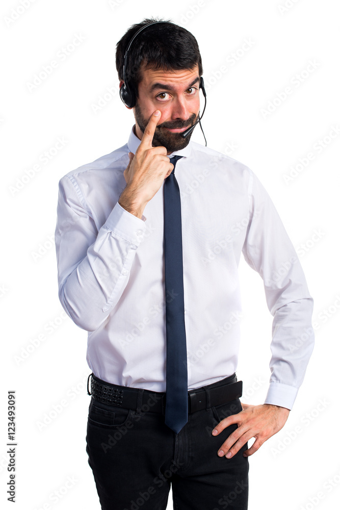 Young man with a headset showing something Young man with a headset showing something