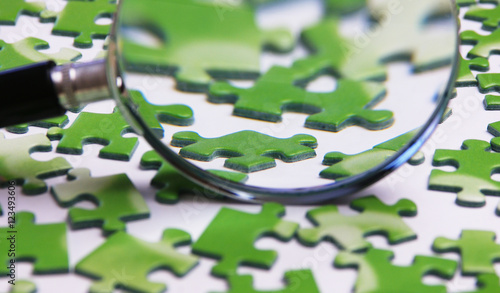 magnifying glass on the green puzzle photo