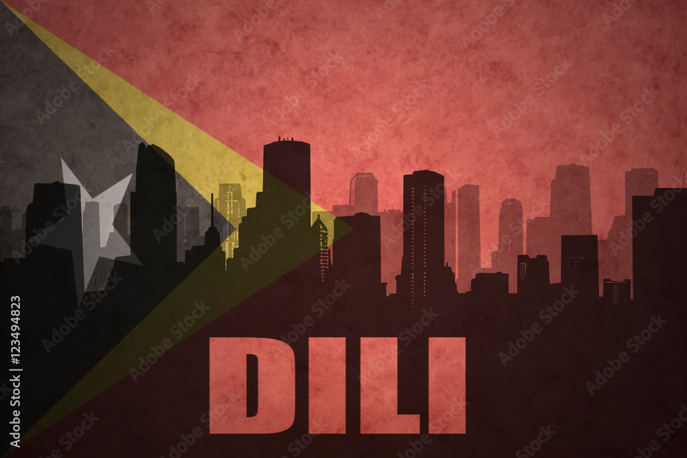 abstract silhouette of the city with text Dili at the vintage east timor flag background