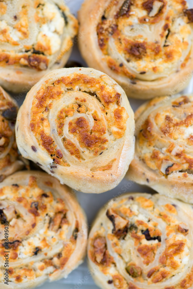 Freshly baked cheese bun rolls with herbs on a plate Freshly baked cheese bun rolls with herbs on a plate