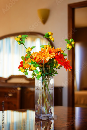 Vase flower on table decoration in vintage hotel room