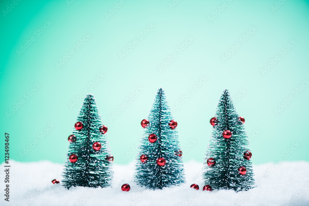 Obraz premium Christmas trees with decoration in snow