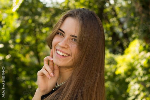 Young woman smiling on the background of trees
