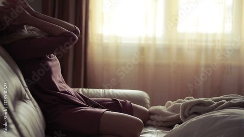 Depressed woman in bed. girl crying on the couch. acute mountain