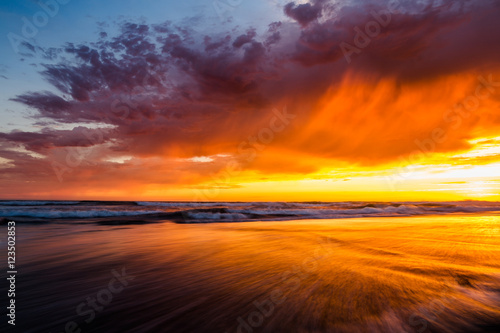 Sunset sky with ocean waves on the beach in La Jolla, California