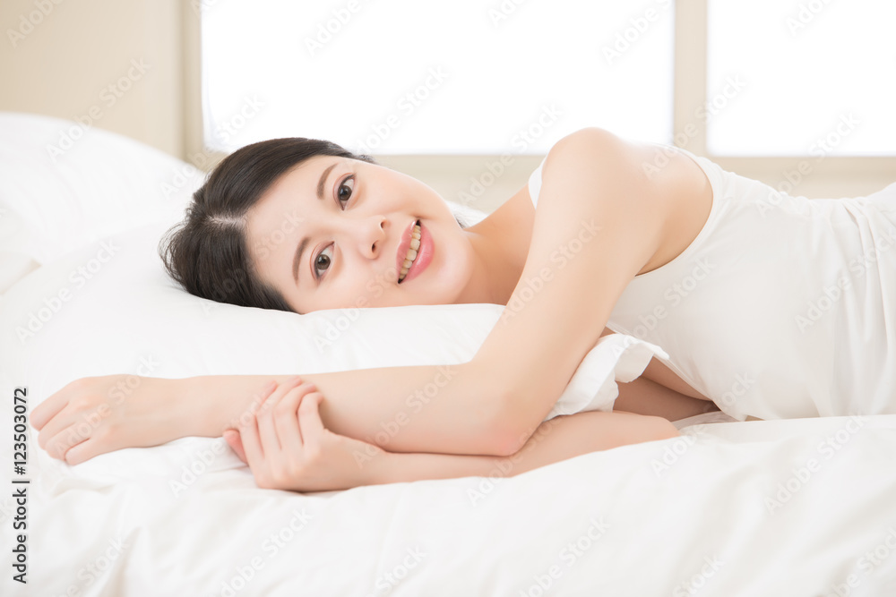 happy beautiful health asian woman feel carefree lying on bed happy beautiful health asian woman feel carefree lying on bed