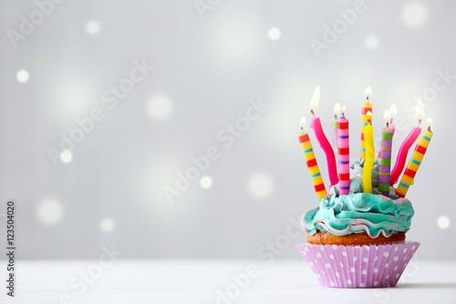 Photography Delicious birthday cupcake on light background