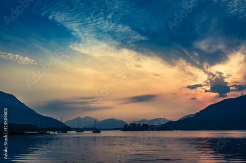 Beautiful sunset over the boats on lake in Scotland