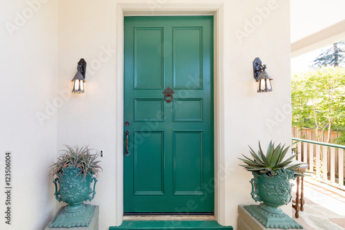 Green entry door with door knock. photo