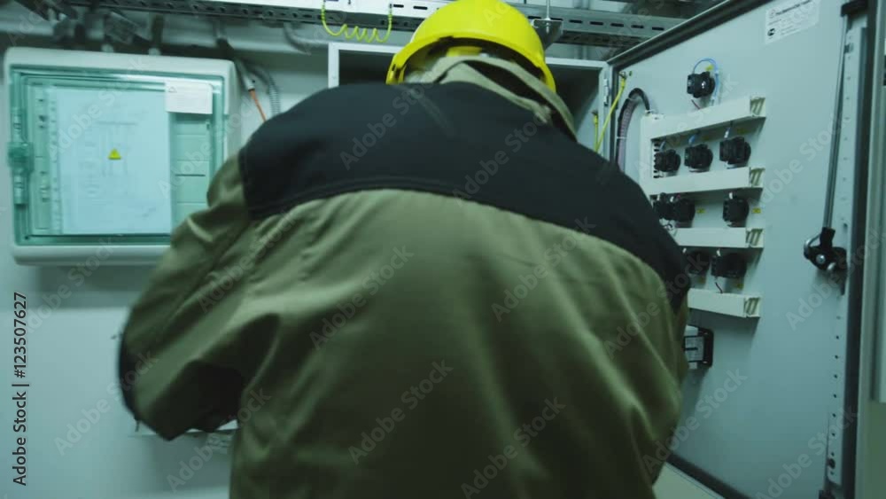man doing electrical metering equipment man doing electrical metering equipment