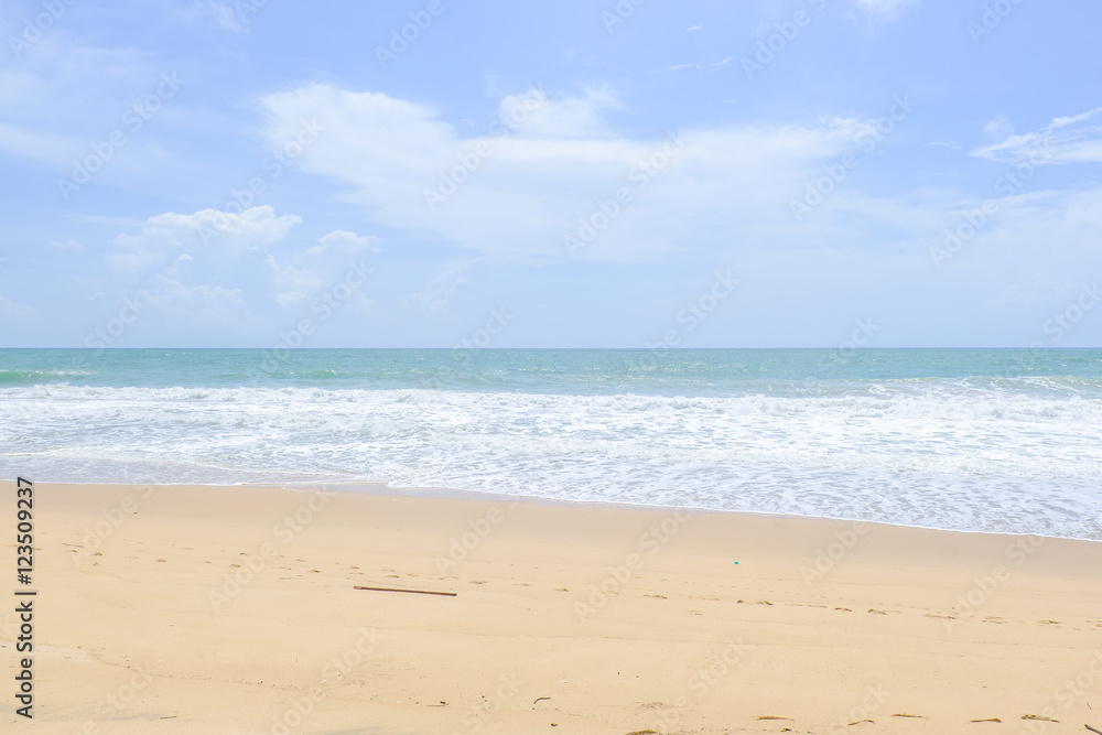 Empty sandy beach with sea under blue sky in thailand