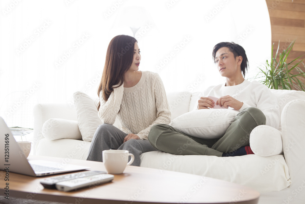 Young couple are talking happily in the living room Young couple are talking happily in the living room