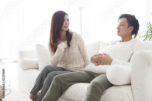 Young couple are talking happily in the living room