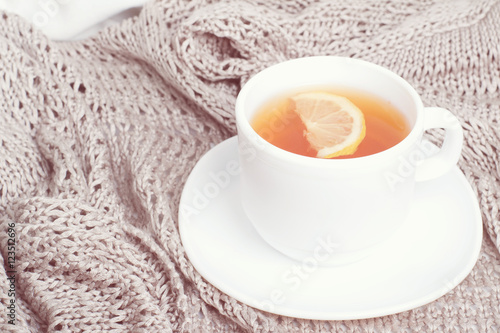 Having a cup of tea on gray blanket in bed.toned foto