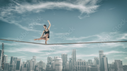 Gymnast tightrope above city