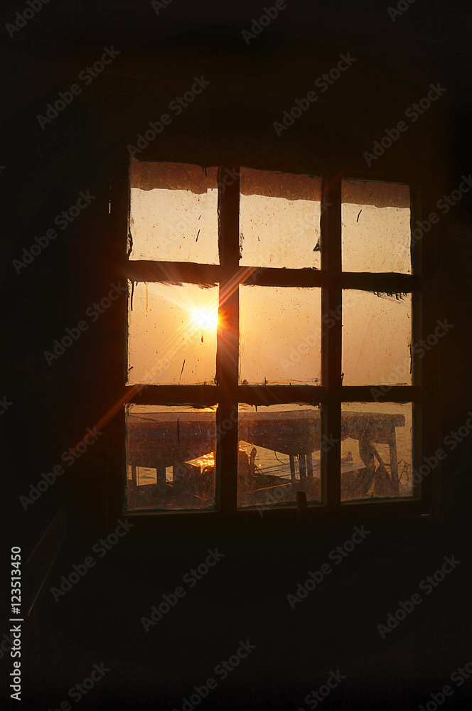 Rays of the setting sun shining through windows of the boat tonle sap lake. Cambodia Rays of the setting sun shining through windows of the boat tonle sap lake. Cambodia